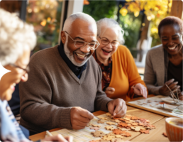 Photograph of various adults of different ethnicities working on a puzzle, the AZUR Study for adults with colon cancer